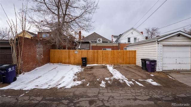 snowy yard featuring fence