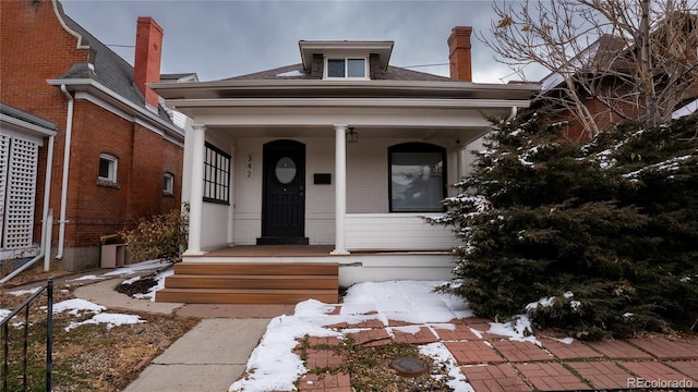 view of front of house featuring a porch and roof with shingles