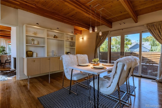 dining space featuring beamed ceiling, wooden ceiling, and light hardwood / wood-style floors