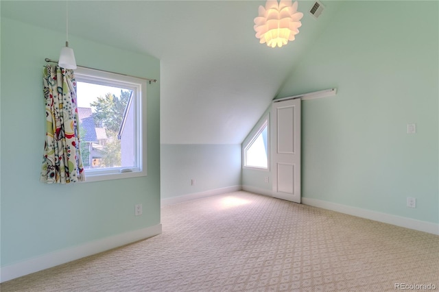 additional living space featuring a wealth of natural light, carpet flooring, and lofted ceiling