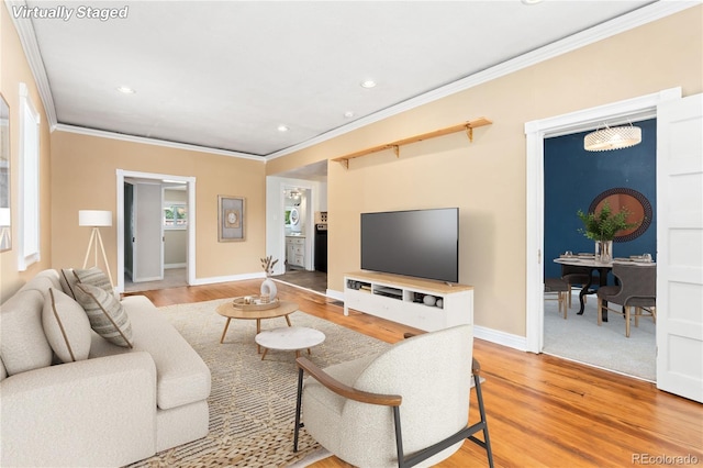 living room with wood-type flooring and ornamental molding