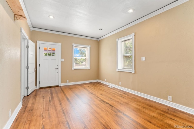 entrance foyer featuring hardwood / wood-style flooring and ornamental molding