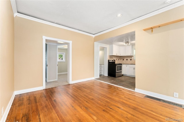 unfurnished living room featuring dark hardwood / wood-style floors and ornamental molding