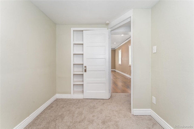 unfurnished room featuring light carpet