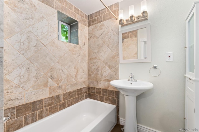 bathroom featuring tiled shower / bath and sink