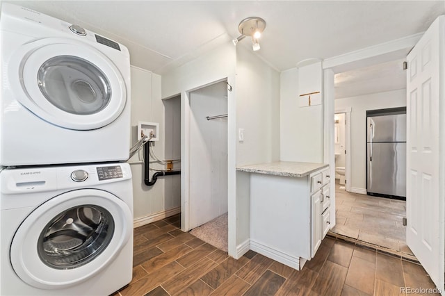 laundry room featuring stacked washing maching and dryer