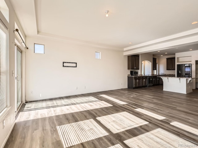 unfurnished living room with dark hardwood / wood-style floors