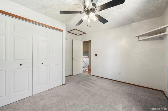 8679 Apache Plume Dr, Parker, CO 80134 - unfurnished bedroom with light colored carpet, a closet, a textured ceiling, baseboards, and ceiling fan