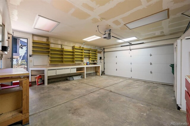 8679 Apache Plume Dr, Parker, CO 80134 - garage with a workshop area and a garage door opener