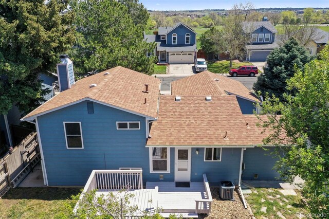 8679 Apache Plume Dr, Parker, CO 80134 - rear view of house with roof with shingles, central air condition unit, and a chimney