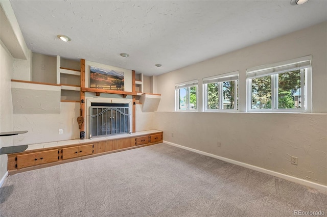 8679 Apache Plume Dr, Parker, CO 80134 - unfurnished living room with carpet, baseboards, and a fireplace with raised hearth