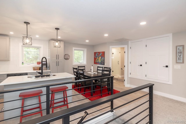 675 Gcr 462, Grand Lake, CO 80447 - kitchen featuring a sink, baseboards, an island with sink, light countertops, and recessed lighting