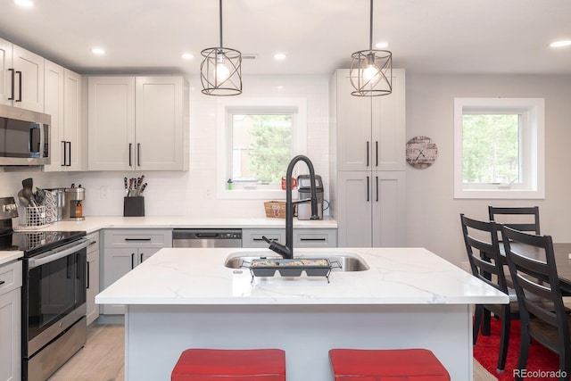 675 Gcr 462, Grand Lake, CO 80447 - kitchen with stainless steel appliances, a sink, light stone countertops, hanging light fixtures, and recessed lighting