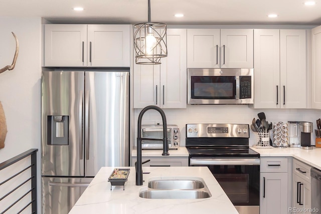 675 Gcr 462, Grand Lake, CO 80447 - kitchen with stainless steel appliances, backsplash, recessed lighting, light stone countertops, and hanging light fixtures