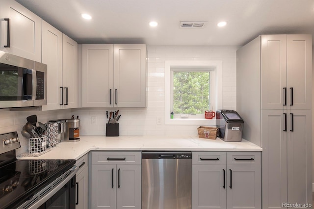 675 Gcr 462, Grand Lake, CO 80447 - kitchen with appliances with stainless steel finishes, tasteful backsplash, recessed lighting, and light stone countertops