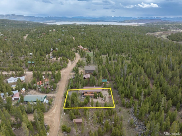 675 Gcr 462, Grand Lake, CO 80447 - aerial view of property and surrounding area featuring a heavily wooded area, a mountainous background, and property boundaries highlighted
