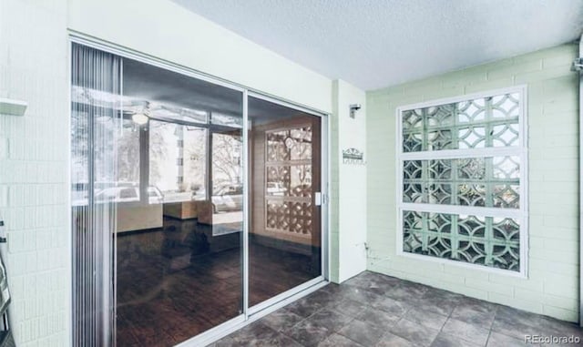 interior space with dark tile flooring and a textured ceiling