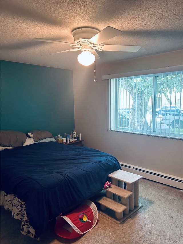 bedroom with carpet, a textured ceiling, ceiling fan, and a baseboard heating unit