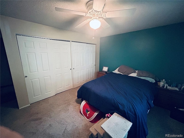 carpeted bedroom with a textured ceiling and ceiling fan