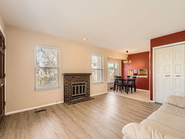 living room featuring visible vents, a wealth of natural light, and wood finished floors