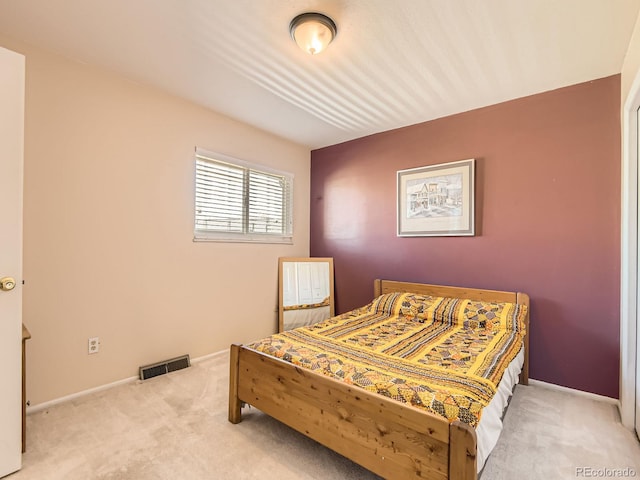 carpeted bedroom with visible vents and baseboards