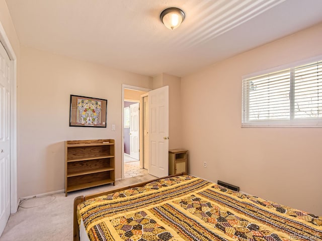 bedroom featuring light carpet