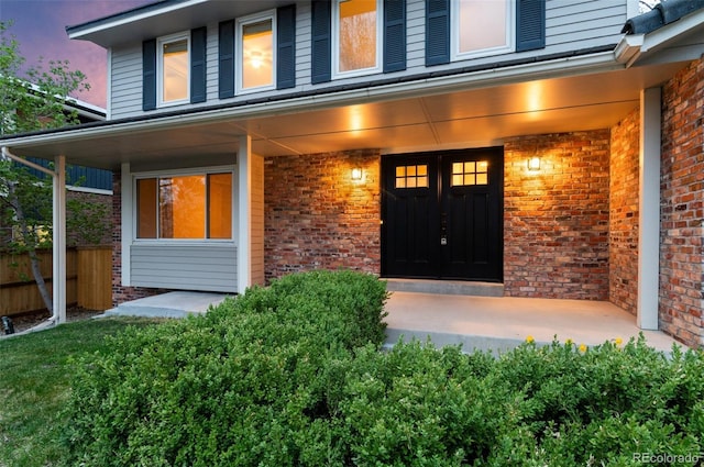 8132 Lodgepole Trl, Lone Tree, CO 80124 - property entrance with brick siding, fence, and covered porch