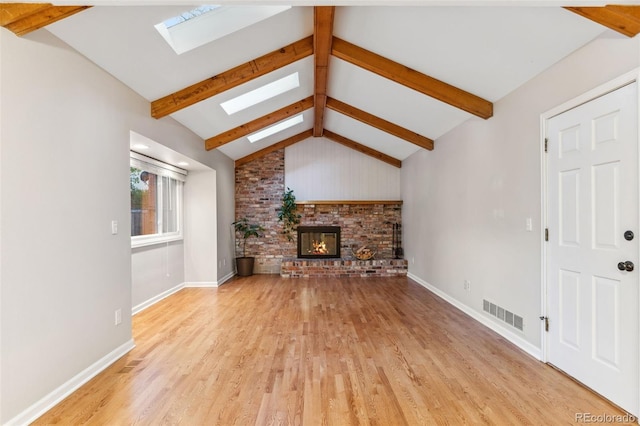 8132 Lodgepole Trl, Lone Tree, CO 80124 - unfurnished living room with baseboards, light wood finished floors, lofted ceiling with skylight, and a fireplace