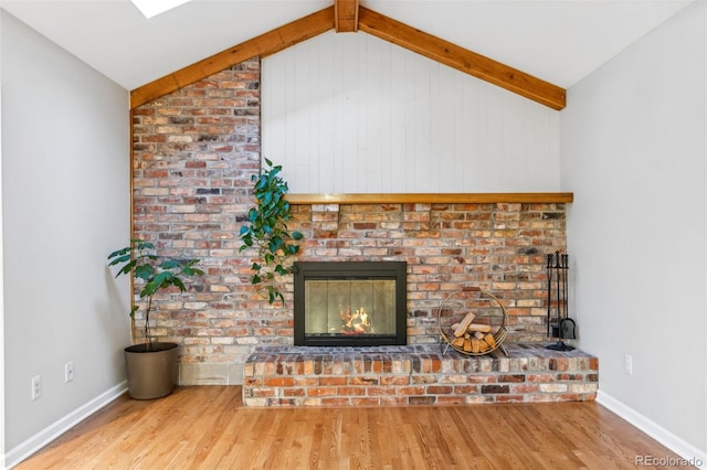 8132 Lodgepole Trl, Lone Tree, CO 80124 - unfurnished living room with vaulted ceiling with beams, baseboards, wood finished floors, and a fireplace
