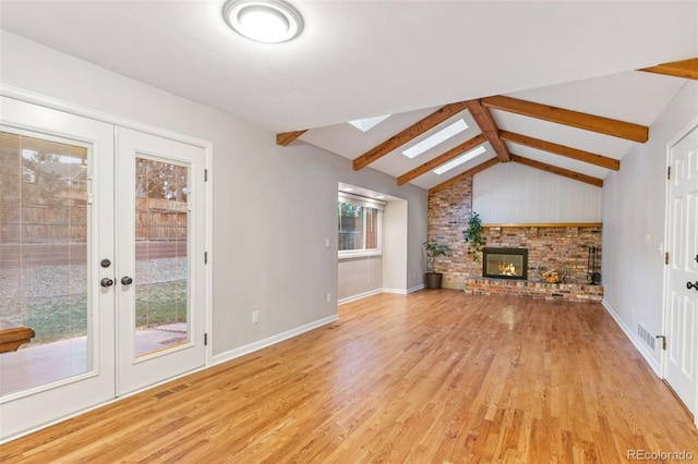 8132 Lodgepole Trl, Lone Tree, CO 80124 - unfurnished living room featuring a fireplace, baseboards, lofted ceiling with skylight, french doors, and light wood-style flooring