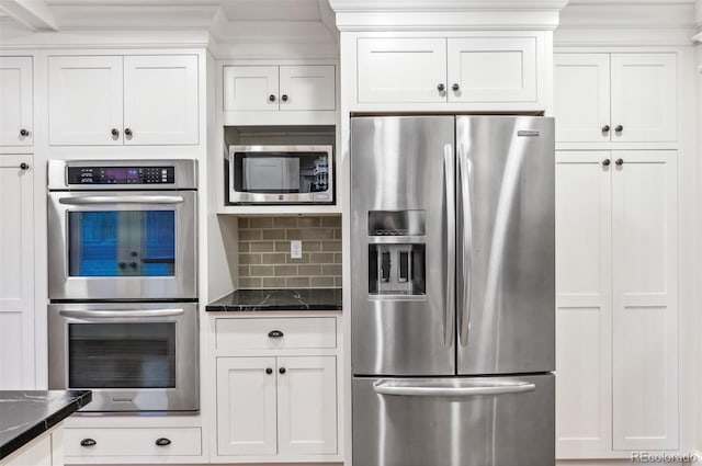 8132 Lodgepole Trl, Lone Tree, CO 80124 - kitchen with decorative backsplash, dark stone countertops, appliances with stainless steel finishes, and white cabinets