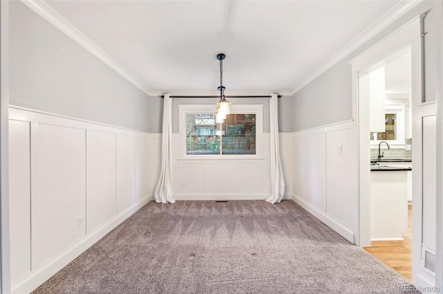 8132 Lodgepole Trl, Lone Tree, CO 80124 - unfurnished dining area featuring crown molding, a sink, and a decorative wall