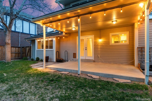 8132 Lodgepole Trl, Lone Tree, CO 80124 - back of house at dusk featuring fence, a patio, and a lawn