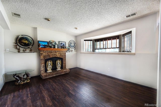 4362 Nepal St, Denver, CO 80249 - living area with wood finished floors, a textured ceiling, and a brick fireplace