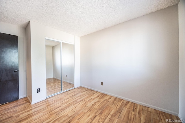 4362 Nepal St, Denver, CO 80249 - unfurnished bedroom featuring light wood-style floors, a closet, and a textured ceiling