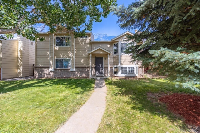 4362 Nepal St, Denver, CO 80249 - view of front of home featuring brick siding and a front yard