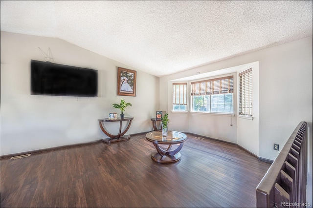 4362 Nepal St, Denver, CO 80249 - living room with lofted ceiling, wood finished floors, a textured ceiling, radiator heating unit, and stairway