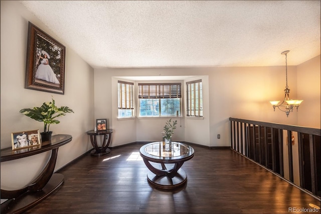 4362 Nepal St, Denver, CO 80249 - sitting room featuring a chandelier, dark wood-style flooring, and a textured ceiling
