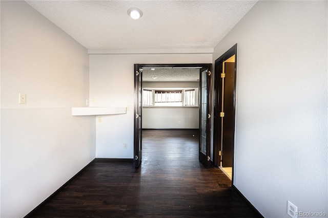 4362 Nepal St, Denver, CO 80249 - hallway featuring dark wood-style floors and a textured ceiling