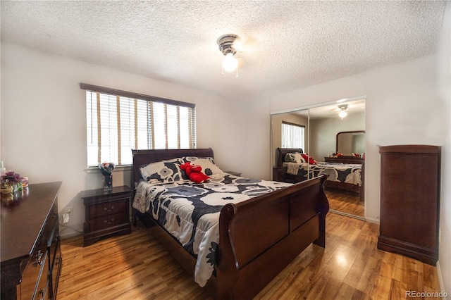 4362 Nepal St, Denver, CO 80249 - bedroom featuring light wood finished floors, a closet, a textured ceiling, and a ceiling fan