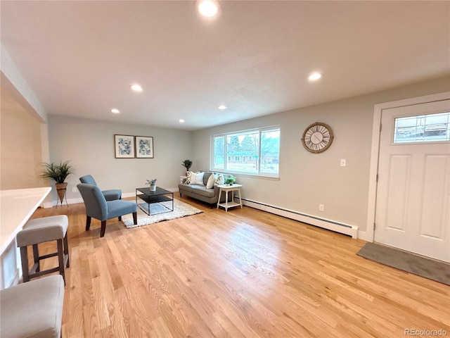 living room with baseboards, light wood finished floors, baseboard heating, and recessed lighting