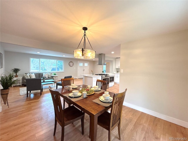 dining room featuring recessed lighting, light wood-style flooring, and baseboards