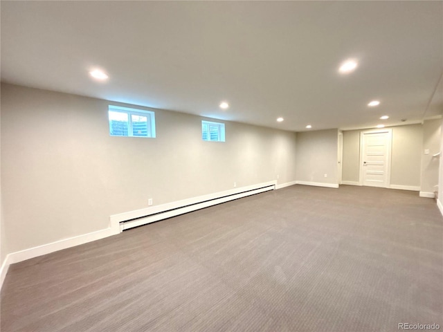 basement with baseboards, baseboard heating, dark carpet, and recessed lighting