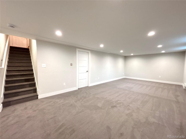 finished below grade area featuring stairs, baseboards, carpet flooring, and recessed lighting