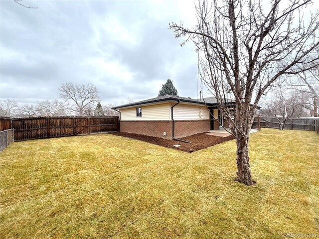 view of yard with a fenced backyard