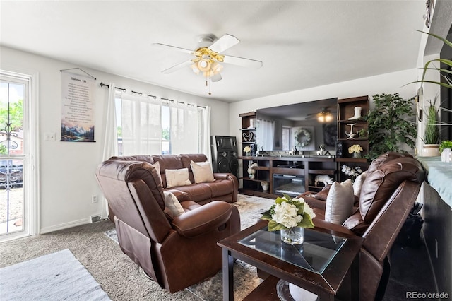 12167 E Exposition Ave, Aurora, CO 80012 - carpeted living room featuring ceiling fan, healthy amount of natural light, and baseboards