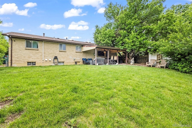 12167 E Exposition Ave, Aurora, CO 80012 - back of property with brick siding and a patio area