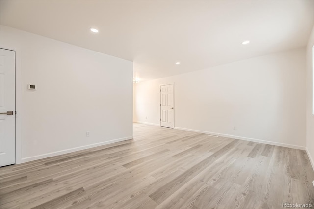 spare room with recessed lighting, light wood-style flooring, and baseboards