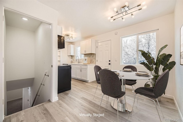 dining area with light wood-type flooring and baseboards