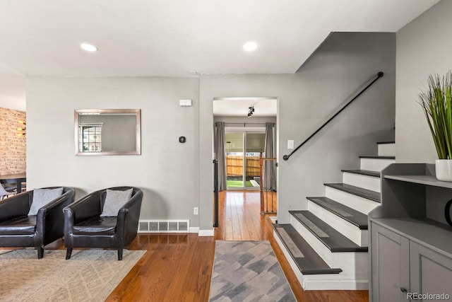 foyer with visible vents, recessed lighting, stairway, and wood-type flooring